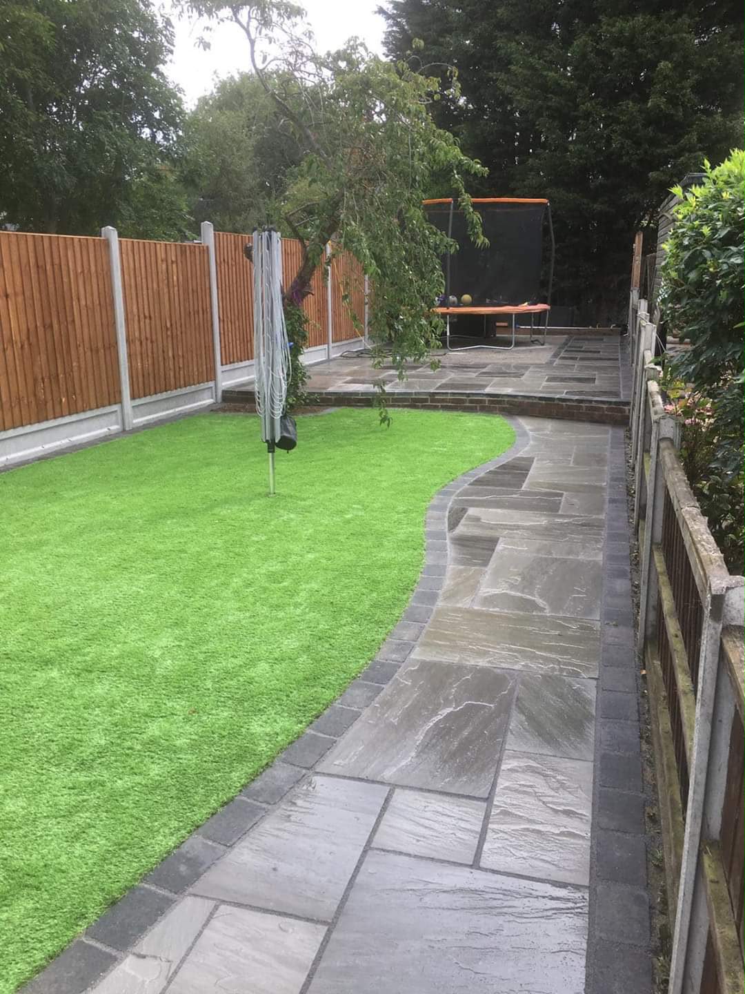 Sandstone block path winding through a lawn