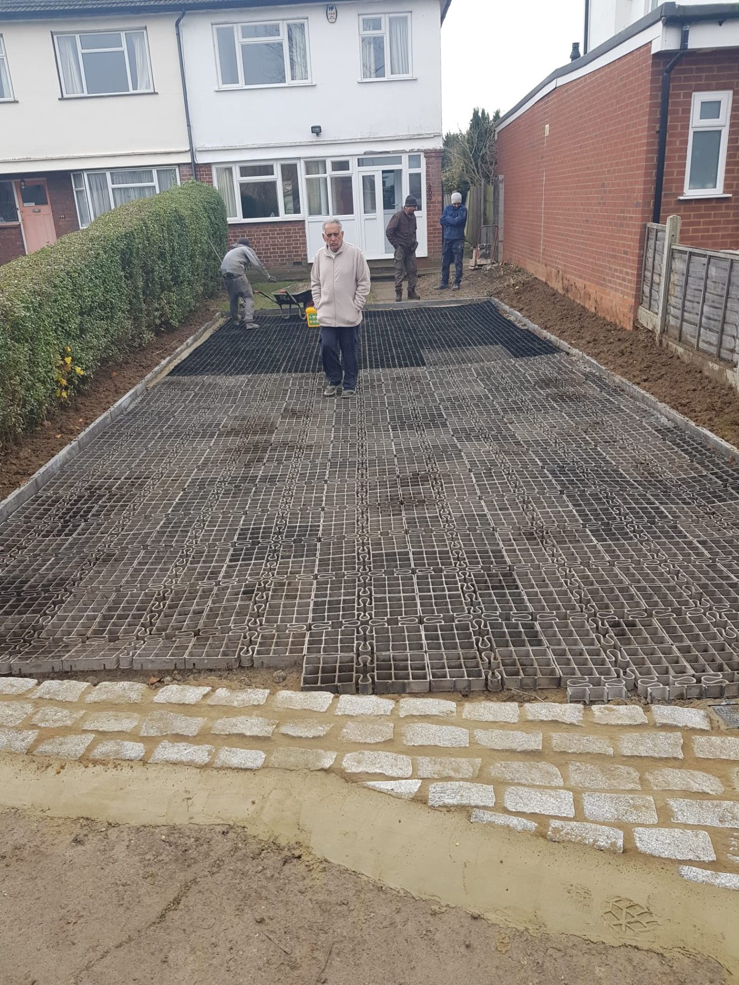 After — Tired gravel driveway transformed with block paving and a granite cobble border