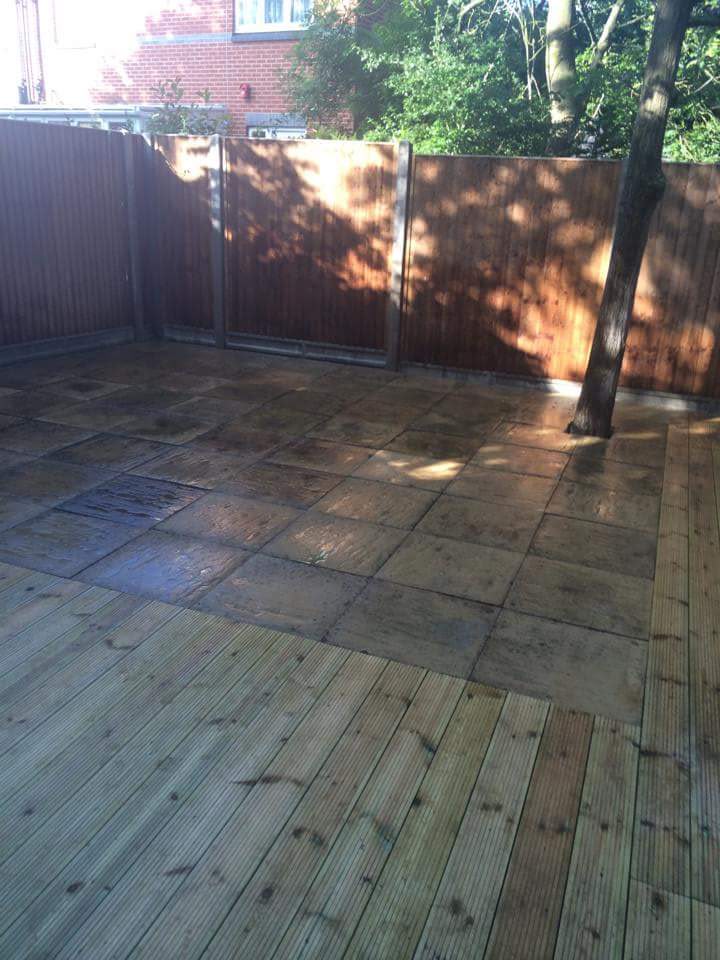 Timber pergola over a garden seating area with clean deck flooring beneath