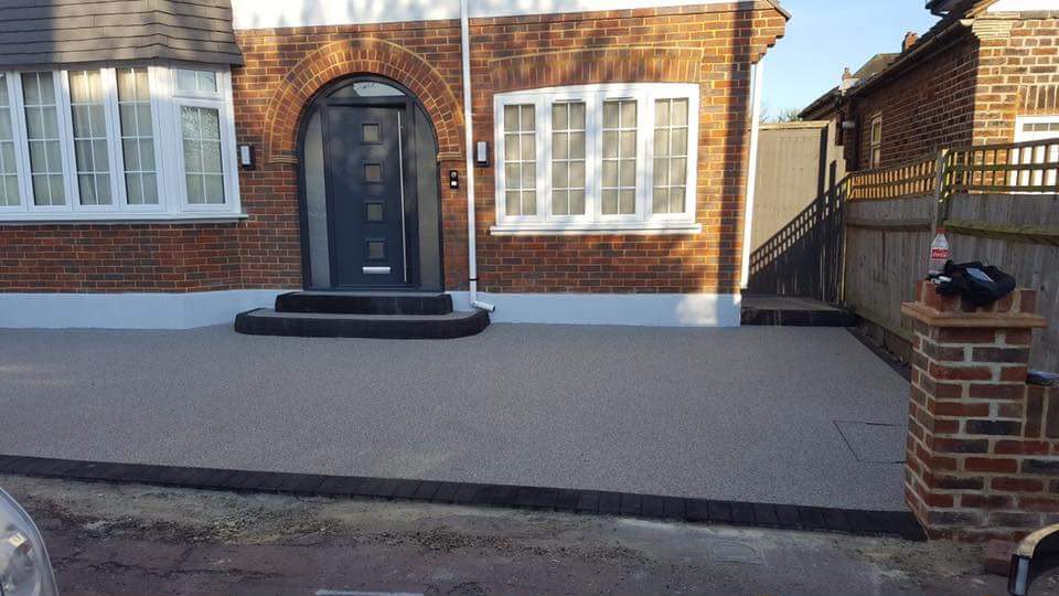 Golden resin-bound driveway with brick edging